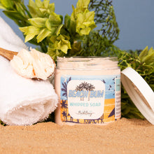 Load image into Gallery viewer, Beach-themed whipped soap bar with 'Beach Bum' label on sand and greenery background