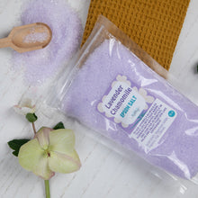 Load image into Gallery viewer, Packaging of lavender chamomile bath salt with a wooden scoop and flower on a white surface