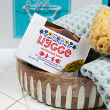 Load image into Gallery viewer, Handmade soap in a wooden basket with a HYGGO label, surrounded by bath items.