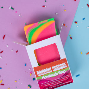 Colorful handmade soap with packaging on a multicolored background