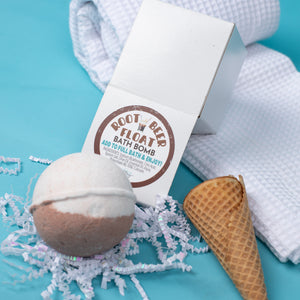 Root beer float bath bomb with packaging on a blue background