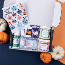Load image into Gallery viewer, Halloween-themed gift set with products and decorative items on a colorful background