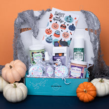 Load image into Gallery viewer, Halloween-themed gift set with pumpkins and decorative elements on an orange background