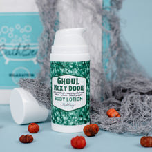 Load image into Gallery viewer, Body lotion bottle labeled &#39;Ghoul Next Door&#39; with pump on a blue background