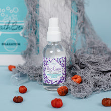 Load image into Gallery viewer, Hand sanitizer spray bottle with a purple label on a light blue background with pumpkins.