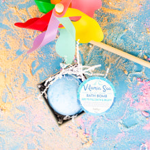Load image into Gallery viewer, Bath bomb with a colorful windmill toy on a textured surface
