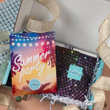 Load image into Gallery viewer, A gift box open to reveal a colorful 'Summer party's' insert card and a black polka-dot notebook with a matching tag, styled with gold ribbon and shredded paper.