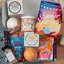 Load image into Gallery viewer, A curated summer bath and body gift box filled with multiple themed products including a foot float bath bomb, whipped soap, bubble salt, sprinkles, and a colorful 'Summer party' bag, arranged in a top-down view.