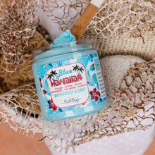 Load image into Gallery viewer, A jar of Blue Hawaii whipped soap by Bath Bevy, filled with light blue whipped soap and topped with a dollop, set in a styled flat-lay with a bamboo spoon, white coconut, and beige netting.