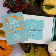 Load image into Gallery viewer, A styled flat-lay of a BathBevy Tubless box set in autumn colors. The open white box reveals a light blue card reading 'hello autumn' decorated with fall leaves, acorns, and a mushroom, alongside a light blue card with the BathBevy logo and 'RELAXATION' text.