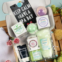 Load image into Gallery viewer, Spa day gift set with bath bombs, soap, and other items in a box.