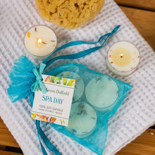 Load image into Gallery viewer, Spa-themed items including candles and bath bombs on a towel with a 'Green Daffodil' label.