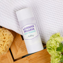 Load image into Gallery viewer, Body powder container labeled 'Lavender Dreamer' with a sponge and flower on a wooden surface.