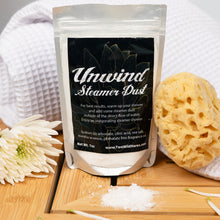 Load image into Gallery viewer, Unwind Steamer Dust packaging with a sponge and flowers on a wooden surface