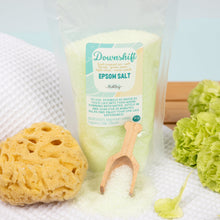 Load image into Gallery viewer, Epsom salt container with a yellow sponge and green flowers on a light background