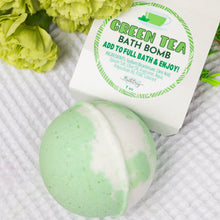 Load image into Gallery viewer, Green tea bath bomb with packaging on a textured surface with green flowers.
