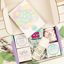 Load image into Gallery viewer, Assorted bath and body products in a box with colorful packaging.