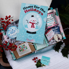 Load image into Gallery viewer, Holiday-themed gift set with a snowman book and decorative items on a white surface.