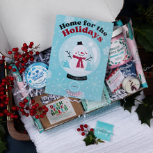 Load image into Gallery viewer, Christmas-themed gift set with 'Home for the Holidays' book and decorative items.