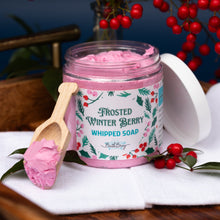 Load image into Gallery viewer, Jar of Frosted Winter Berry Whipped Soap with a wooden spoon on a white surface with red berries in the background.