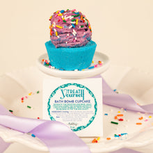 Load image into Gallery viewer, Bath bomb cupcake with colorful sprinkles and a visible label on a white background