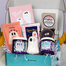 Load image into Gallery viewer, A Halloween-themed gift box filled with bath and beauty treats, including a pink Boo card, Latika orange pouch, Spooky fizzy dust, a white ghost-shaped bath bomb, and purple jars of whipped soap and whipped soap scub, arranged in a turquoise box with white paper shred.