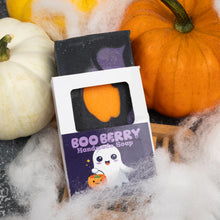 Load image into Gallery viewer, A Halloween-themed handmade soap bar in a white and purple box labeled 'BOO BERRY Handmade Soap,' styled with pumpkins, cobweb decorations, and a wooden spoon on a dark surface.