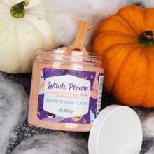 Load image into Gallery viewer, A jar of whipped soap scrub labeled 'Witch, Please' sits on a dark surface with a white lid beside it, styled with pumpkins and white faux fur. The scrub inside appears peachy pink, and the label is purple with decorative Halloween-themed graphics.