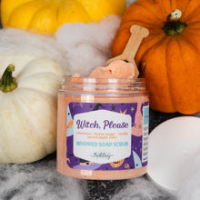 Load image into Gallery viewer, A jar of 'Witch, Please' whipped soap scrub by Bath Bevy, styled with orange and white pumpkins, white faux cobwebbing, and a wooden scoop on a dark gray background.