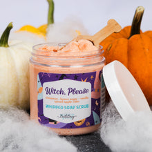 Load image into Gallery viewer, A jar of whipped soap scrub labeled 'Witch, Please' by Bitter Berry, styled with pumpkins, white faux cobwebs, and a wooden scoop on a dark surface against a light background.