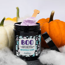 Load image into Gallery viewer, A jar of Boo Whipped Soap by Bath Bevy, filled with purple whipped soap and topped with a wooden spoon, styled with pumpkins and white faux cobwebbing.