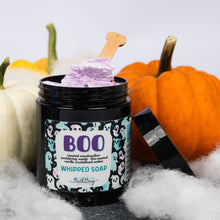 Load image into Gallery viewer, A jar of Boo Whipped Soap by Bath Bevy, filled with purple whipped soap and topped with a wooden spoon, styled with pumpkins and white faux cobwebbing.