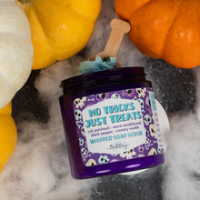 Load image into Gallery viewer, A jar of whipped soap scrub labeled 'No Tricks Just Treats' by Bath Bevy styled with pumpkins and white faux fur on a dark surface.