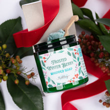 Load image into Gallery viewer, A jar of frosted winter berry whipped soap by Bath Bevy, styled with a wooden spoon, gift box, and festive red ribbon and green leaves on a white background.