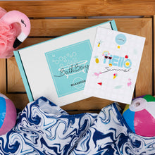 Load image into Gallery viewer, Bath and body products including a bath bomb, bath towel, and 'Hello Summer' card on a wooden surface.