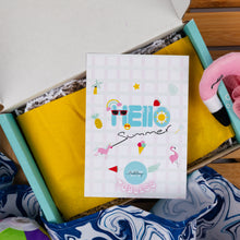 Load image into Gallery viewer, Colorful 'Hello Summer' card inside an open box with a yellow towel and pink flamingo item.