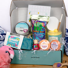 Load image into Gallery viewer, Open box containing various bath products with a focus on soaps and bath items.