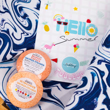 Load image into Gallery viewer, Two shower steamers and a 'Hello Summer' tubless product on a blue and white marbled background.
