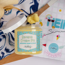 Load image into Gallery viewer, Jar of Banana Cream Pie whipped soap scrub with a 'Hello Summer' towel in the background