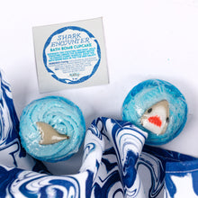 Load image into Gallery viewer, Shark-themed bath bomb cupcake with packaging on a white background