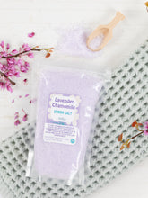Load image into Gallery viewer, Packaged lavender chamomile epson salt on a textured surface with flowers and a wooden scoop.