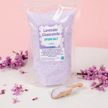 Load image into Gallery viewer, Bag of lavender chamomile Epsom salt with a wooden scoop and pink flowers on a light background