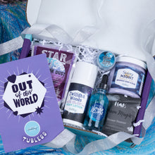Load image into Gallery viewer, An open purple Tubless gift box filled with bath and body products, including Twilight Woods body lotion, Lunar Eclipses dropper bottle, Starry Night whipped body butter, Moon Magic shower steamer, and a purple card reading 'Out of this World.'.
