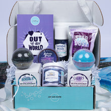 Load image into Gallery viewer, A curated bath gift box set from Bath Bevy, featuring a turquoise box filled with bath products including a purple 'Out of This World' bath bomb, a Twilight Woods body lotion bottle, a Star Dust fuzzy dust, a Galaxy bath bomb, and other themed soaps and scrubs.