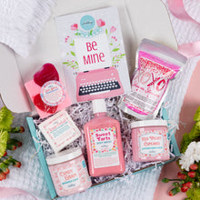 Load image into Gallery viewer, Collection of pink-themed beauty products in a box with decorative elements.