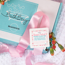 Load image into Gallery viewer, BathBevy relaxation product with a pink ribbon and floral decorations on a white surface.
