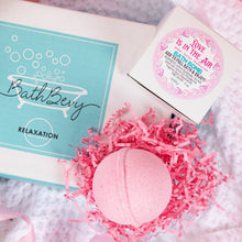 Load image into Gallery viewer, BathBevy product with a pink bath bomb and decorative box on a soft background