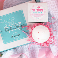Load image into Gallery viewer, Bath bomb with packaging and decorative elements on a soft surface