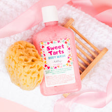 Load image into Gallery viewer, Pink bottle of 'Sweet Tarts' body wash with a sponge and brush on a pink background